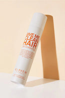 Shampoo bottle labeled 'Give Me Clean Hair' by Eleven on a beige background - Hair Care Canada