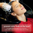 A woman with shampoo lather in her hair relaxes in a salon wash bowl while hands wash her head. A red salon cape is visible, and a text banner at the bottom reads, 'prevent color fade at the bowl' with additional product copy.