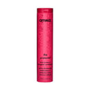 A tall, cylindrical pink bottle of amika. The protector color protectant styling conditioner, featuring black text and a subtle floral pattern on a clean white background.