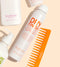 Hair care products including a bottle of 'Dry Finish Texture Spray' and a comb on a beige background - Hair Care Canada