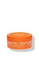Orange jar of matte texture styling paste on a white background - Hair Care Canada