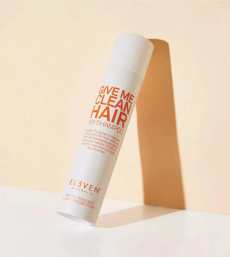 Shampoo bottle labeled 'Give Me Clean Hair' by Eleven on a beige background - Hair Care Canada