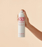 Hand holding a can of 'Give Me Hold Flexible Hairspray' by Eleven on a beige background - Hair Care Canada