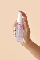 Hand holding a bottle of 'Eleven' hair serum against a beige background - Hair Care Canada
