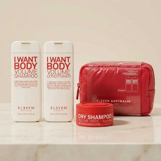 Set of Eleven Australia hair care products including shampoo, conditioner, dry shampoo paste, and travel pouch on a beige background.