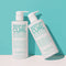 Two bottles of 'Keep My Curl' shampoo and conditioner on a light blue background - Hair Care Canada
