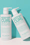 Two bottles of 'Keep My Curl' shampoo and conditioner on a light blue background - Hair Care Canada