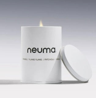 Neuma candle with lid on a gray background - Hair Care Canada