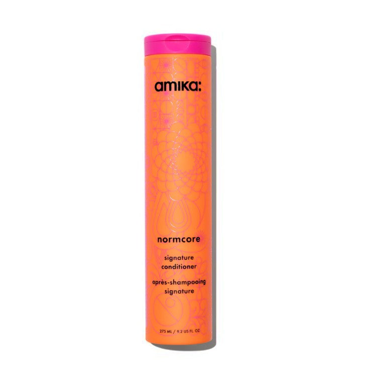 Amika normcore conditioner bottle with pink cap on a white background - Hair Care Canada