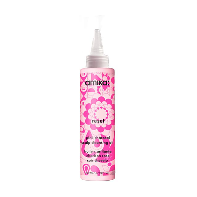 Pink bottle of amika hair product with floral design on a white background - Hair Care Canada