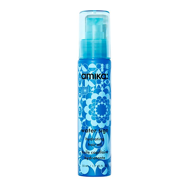 Blue hair oil bottle with floral design on a white background - Hair Care Canada