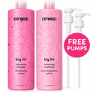 Two pink Amika 'big hit' volumizing shampoo and conditioner bottles shown on a white background, alongside two white pump dispensers and a pink circular badge that reads 'FREE PUMPS'.