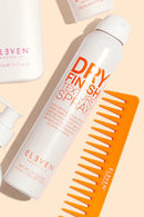 Hair care products including a bottle of 'Dry Finish Texture Spray' and a comb on a beige background Hair Care Canada