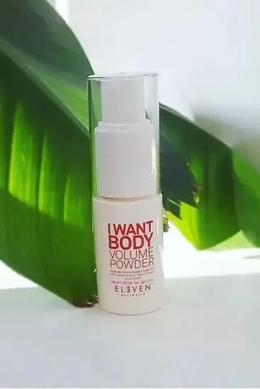Elven Naturals 'I Want Body Volume Powder' bottle with green leaves in the background -Hair Care Canada