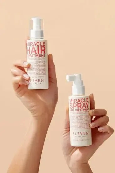 Two bottles of 'Miracle Hair Treatment' and 'Miracle Spray' held by a person against a beige background - Hair Care Canada