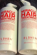 Two bottles of Eleven Australia Miracle Hair Treatment Shampoo and Conditioner on a textured surface Hair Care Canada