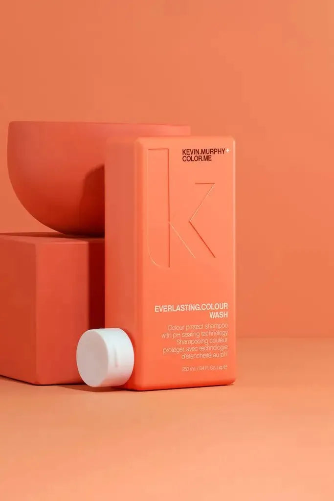 Red Kevin Murphy Everlasting Colour shampoo bottle on an orange background - Hair Care Canada
