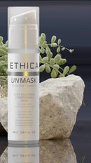 Ethica Unmask Ultra Volumizing Conditioning Mask in a white pump bottle, styled with a large stone and green succulent leaves against a dark navy background.