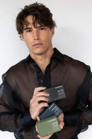 Man holding three business cards against a white background - Hair Care Canada