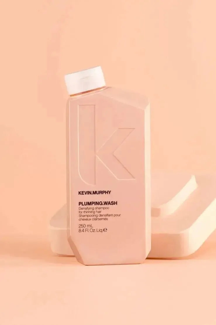 Kevin Murphy Plumping Wash bottle on a peach background - Hair Care Canada