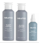Three Neuma hair care bottles on a white background: a large gray shampoo bottle, a large gray conditioner bottle, and a smaller light blue spray bottle- Hair Care Canada