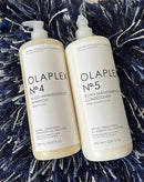 Two white plastic bottles of Olaplex No. 4 Bond Maintenance Shampoo and No.